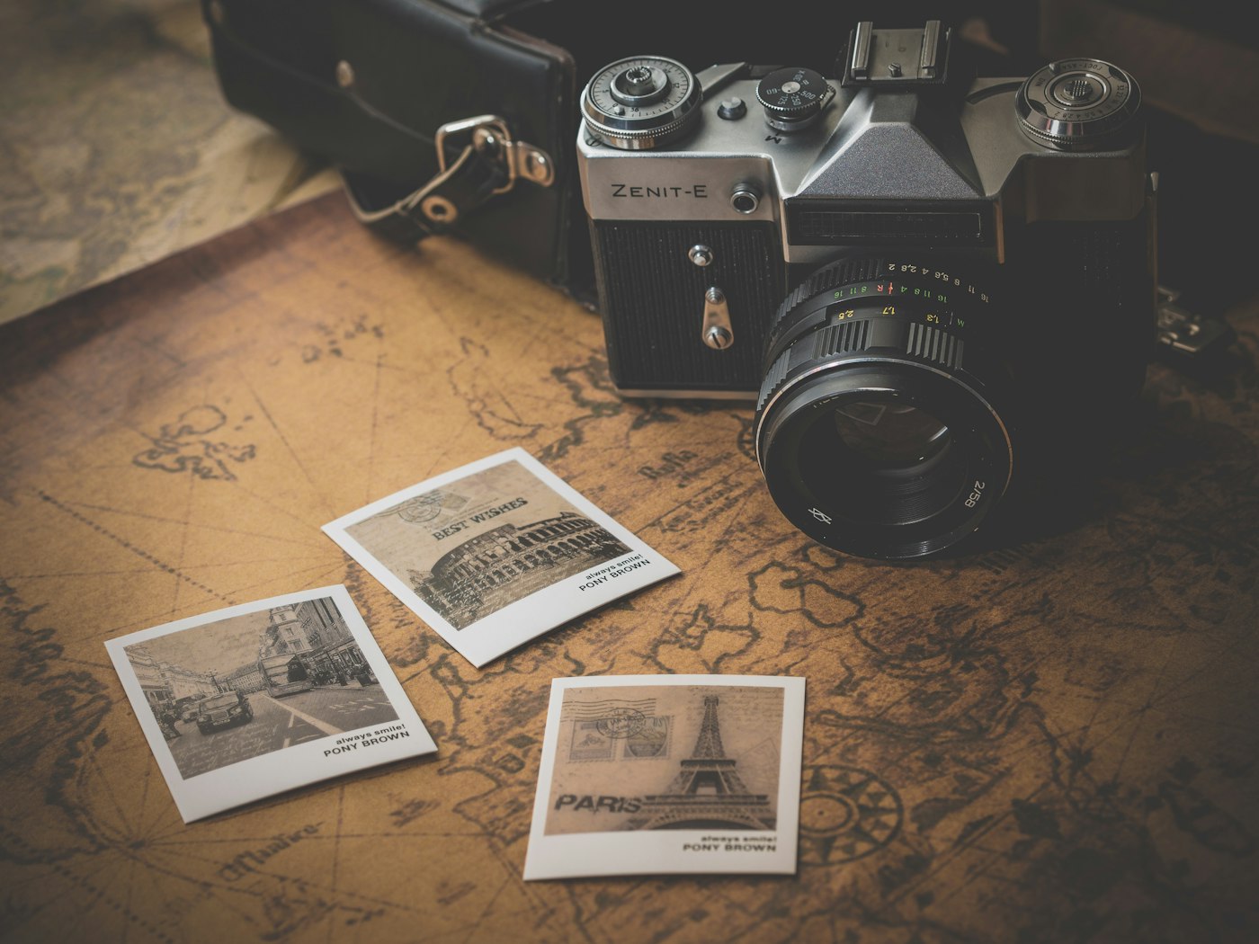Vintage camera and travel photos on a map